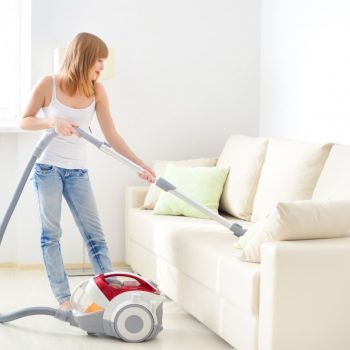 woman vacuuming sofa