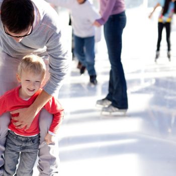 family skating at ice rink
